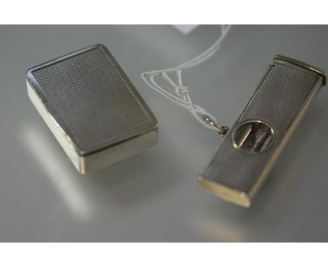 A silver cigar cutter, Birmingham 1962, with engine turned decoration; together with a similarly decorated silver pill box, B