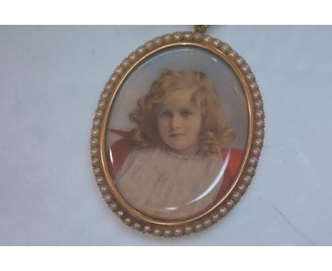 A portrait miniature of a young girl, c. 1900, oval, watercolour on ivory, in a yellow metal mount stamped "15" set with seed