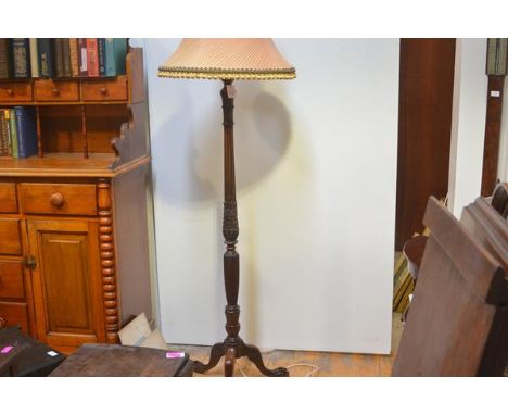 A mahogany columnar standard lamp, early 20th century, the fluted column with leaf and bellflower band, raised on a tripod ba