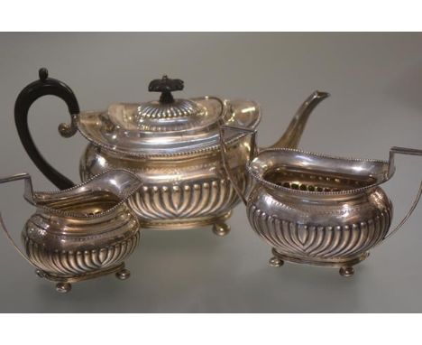 A late Victorian silver three piece tea service, Thomas Bradbury & Sons, London 1894, in the Regency taste, each piece of ova