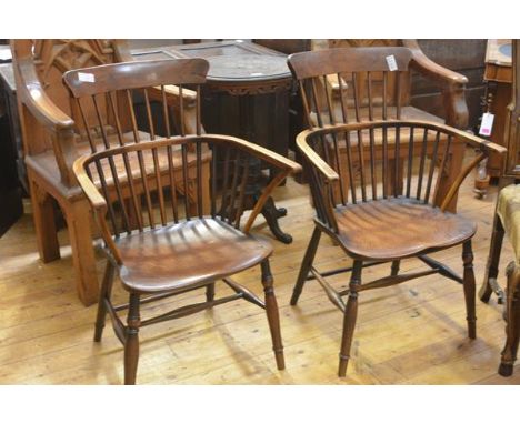 A pair of elm and yew comb back Windsor armchairs, 19th century, the dished seats between bowed arms, on turned splayed legs 