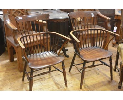 A pair of elm and yew comb back Windsor armchairs, 19th century, the dished seats between bowed arms, on turned splayed legs 