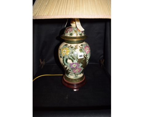 An Oriental table lamp with bird and floral decoration.