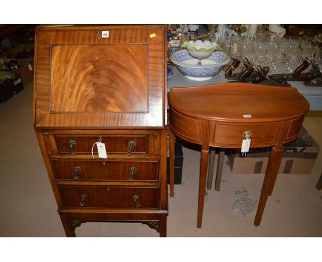 An Edwardian tall narrow mahogany bureau, the fall-flap opening to reveal a fitted interior, fitted three drawers below with 