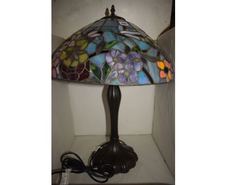 A table lamp with Tiffany style glass shade.