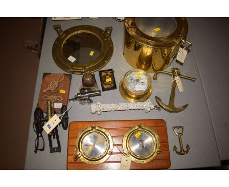 A collection of brass nautical ornaments, including: a miniature diver's helmet; a brass porthole mirror; miniature brass anc