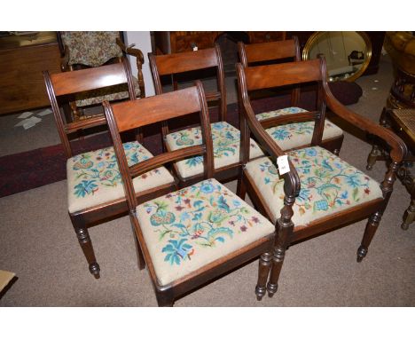 A set of four plus one reproduction mahogany dining chairs with curved cresting rails, the carver with scrolling reeded arms 