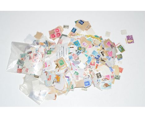 A box of first day covers and loose stamps.