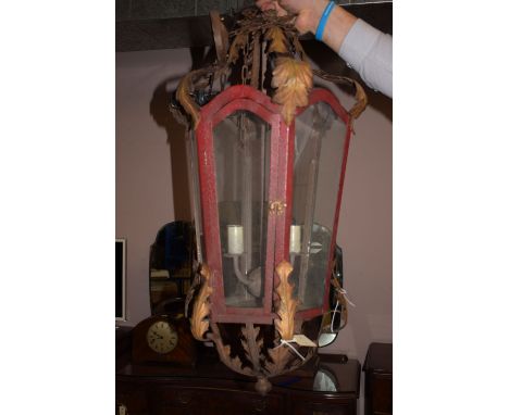 A painted metal lantern with glazed panels.