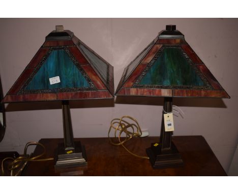 A pair of table lamps with Tiffany style glass shades.