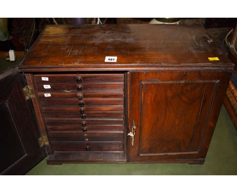 A rosewood table top coin cabinet, fitted two panelled doors opening to reveal a fitted interior of twenty-four drawers.