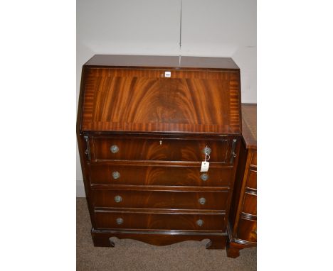 A reproduction mahogany bureau fitted three long drawers, raised on bracket feet.