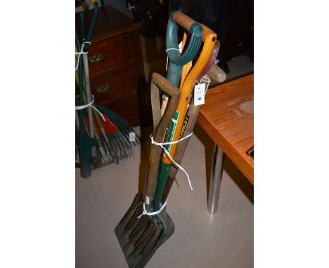 A bundle of garden tools, including: a spade; a shovel; and three forks, various.