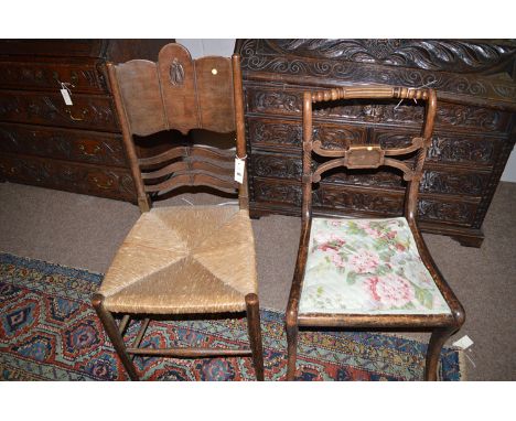 A A Regency salon chair, the curved, carved and turned top rail over a seat upholstered in patterned material, raised on sabr