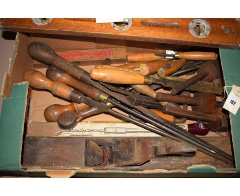 A collection of hand tools, including: chisels; screwdrivers; block plane; spirit level; Yankee screwdriver; and a power bran