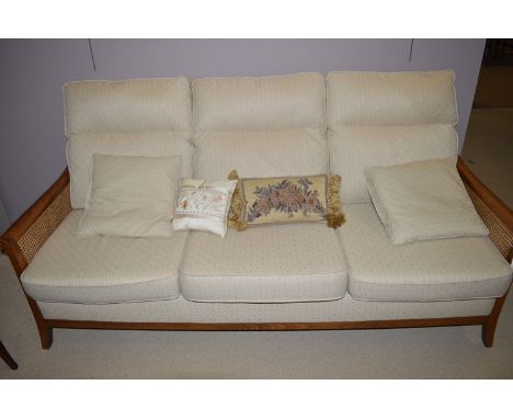 A modern large stained beech framed bergere sofa by Parker Knoll, with loose seat and back cushions, upholstered in cream pat