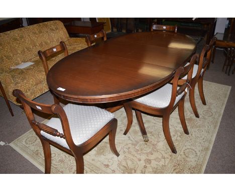 An eight-piece reproduction mahogany Regency style dining suite, comprising: a sideboard with three frieze drawers and cupboa