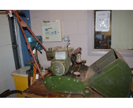 A vintage petrol driven cylinder lawn mower with a plaque inscribed 'Thomas Green & Co., Leeds' and 'London no. 14/4/3407', w