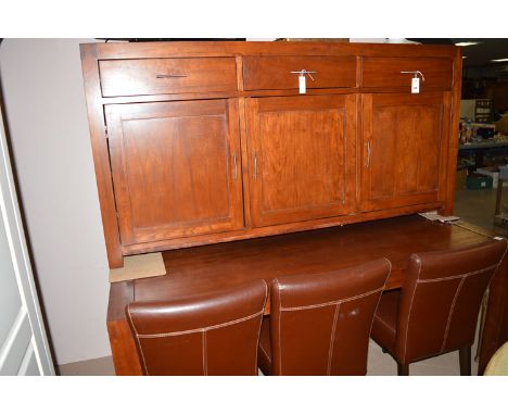 A modern stained wood hardwood dining suite, comprising: a sideboard fitted three drawers above cupboards; a rectangular tabl