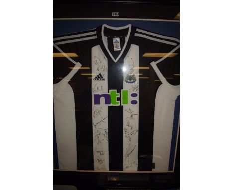 A framed and signed Newcastle United signed shirt.