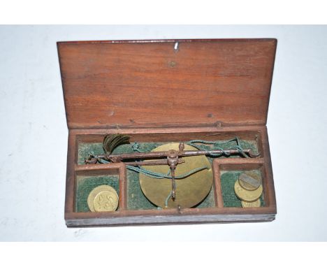 An early 19th Century set of miniature scales, in fitted mahogany box, some brass weights.