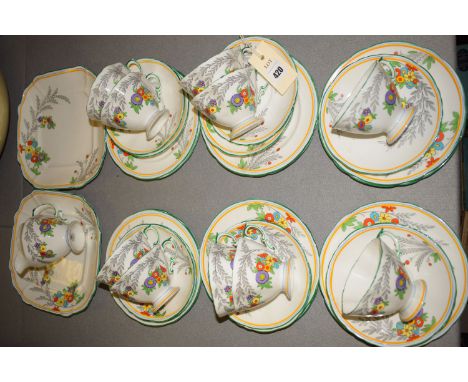 A Hammersley Art Deco style part afternoon tea set, decorated brightly coloured flowers and grey leaves, on white ground with