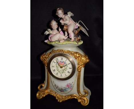 A 19th Century style mantel clock, in modern ceramic case decorated with two putti.
