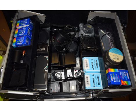 A collection of 35mm camera equipment to include: two Cannon AV1 with speed winders and accessories, in a fitted case.