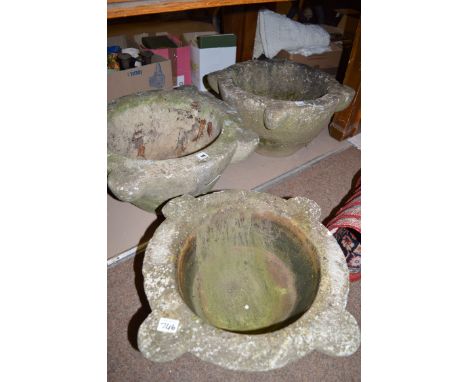 A pair of large cast composition stone circular garden planters with four projecting lugs; and another smaller similar plante
