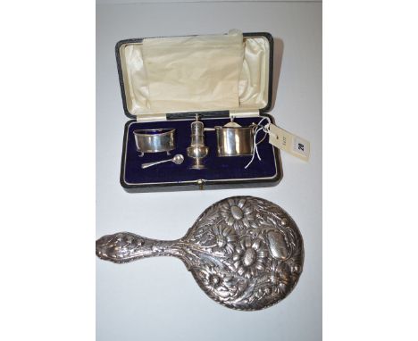 A three-piece silver condiment set, by E.S.B., Birmingham 1915, in fitted case; together with a silver mounted dressing table