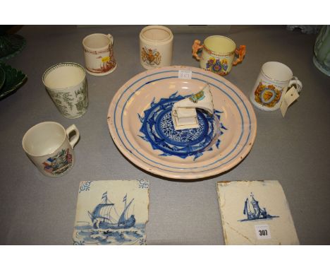 A circular delft dish with underglaze blue decoration; two antique delft tiles; a crested china model of a gramophone by WIll