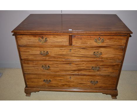A Georgian mahogany chest of drawers, the top with moulded edge above two short and three long graduating drawers with ornate