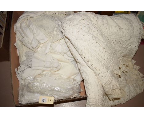 A large hand crocheted cream coloured cotton bed cover; together with a selection of hand-worked table linen.