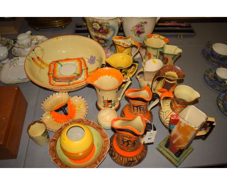 A collection of Art Deco style hand decorated jugs by Myott and others; bowls; and a vase by Shelly, all decorated in bright 