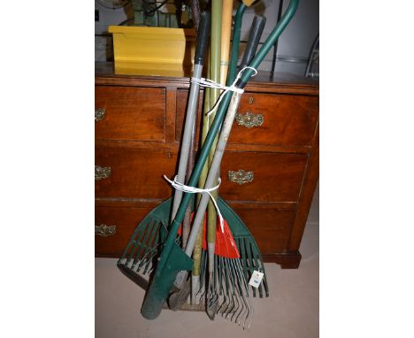 A bundle of garden tools, comprising: rakes; edging shears; etc.