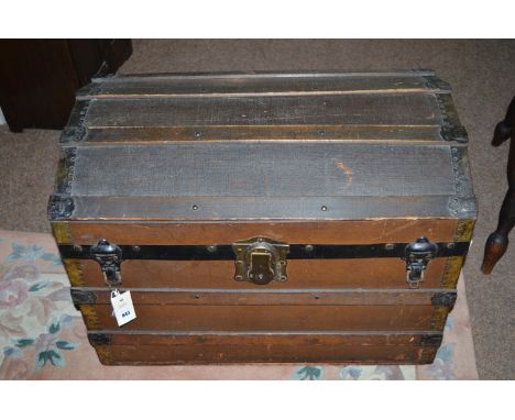 An old wooden trunk with canvas and metal bindings.