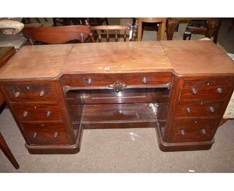 A 19th Century mahogany kneehole dressing table, the top with moulded edge and frieze drawer, fitted three graduating drawers