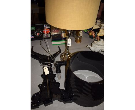 A black plastic table lamp by Kartell, with crinkled shade; and another table lamp.