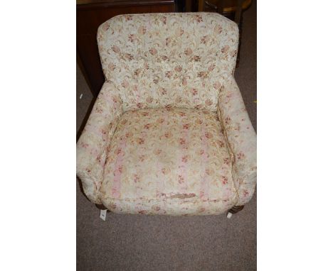 A Victorian nursing chair, the buttoned back, seat and arms upholstered in patterned material, raised on turned and reeded fr