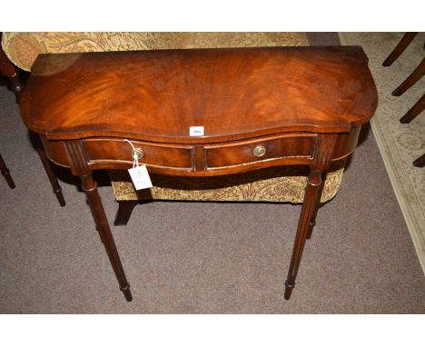 A reproduction mahogany side/hall table, with shaped crossbanded top, fitted two shallow drawers to the frieze, raised on tur