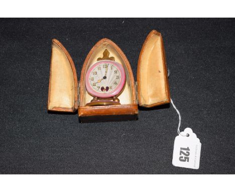 A lady's travelling alarm clock with Swiss movement, in gold plated and pink enamelled case contained in a leather covered ar