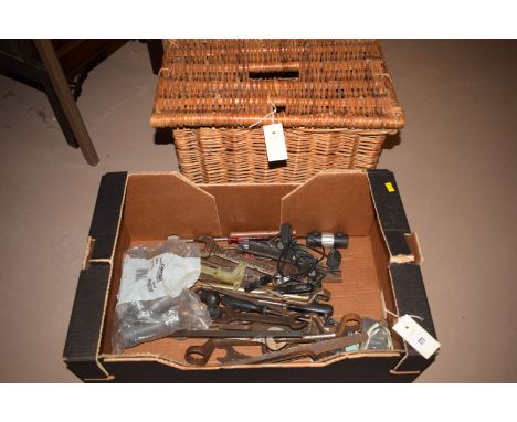 A collection of old hand tools, mainly spanners; etc., for a mechanic; and a rectangular basket with hinged cover.