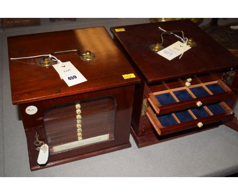 A pair of table top coin cabinets, with glazed doors opening to reveal a fitted interior of twelve drawers to each cabinet.