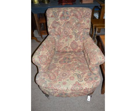 A gent's Victorian armchair with shaped buttoned back, flared arms and a long seat, upholstered in modern patterned material,