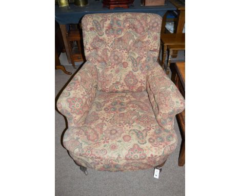 A gent's Victorian armchair with shaped buttoned back, flared arms and a long seat, upholstered in modern patterned material,