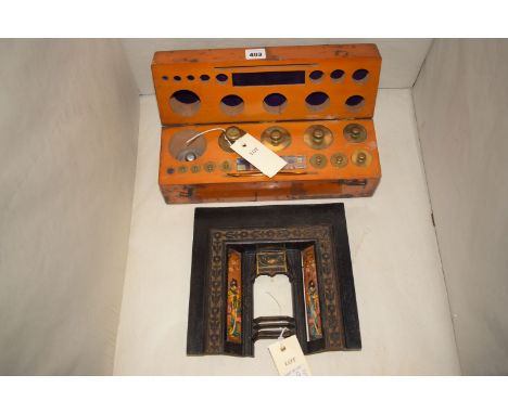 A set of scale weights in a wooden case with FE Becker & Co. label together with; a miniature metal Victorian style fireplace