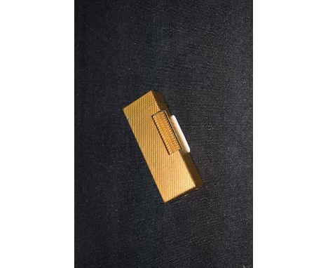 A modern gold coloured Dunhill cigarette lighter.