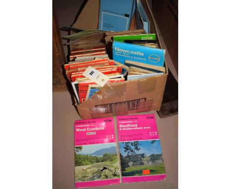 A collection of Ordnance Survey and other maps in a box.