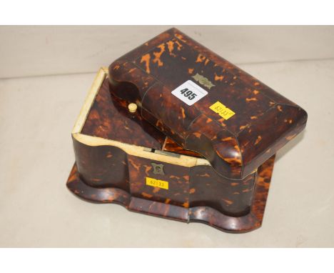 An early 19th Century tortoiseshell tea caddy fitted two compartments and a lid in need of restoration.