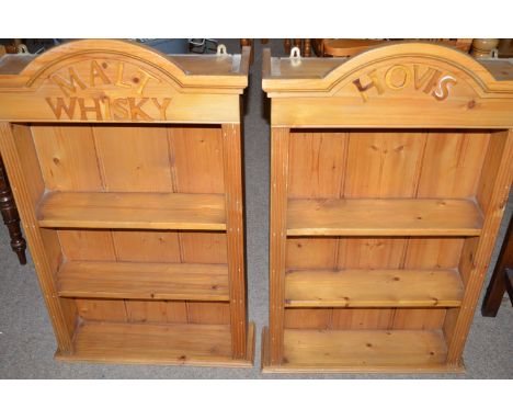 A pair of modern polished pine wall hanging shelf units with arched tops, one inscribed 'Hovis', the other 'Malt Whisky'.